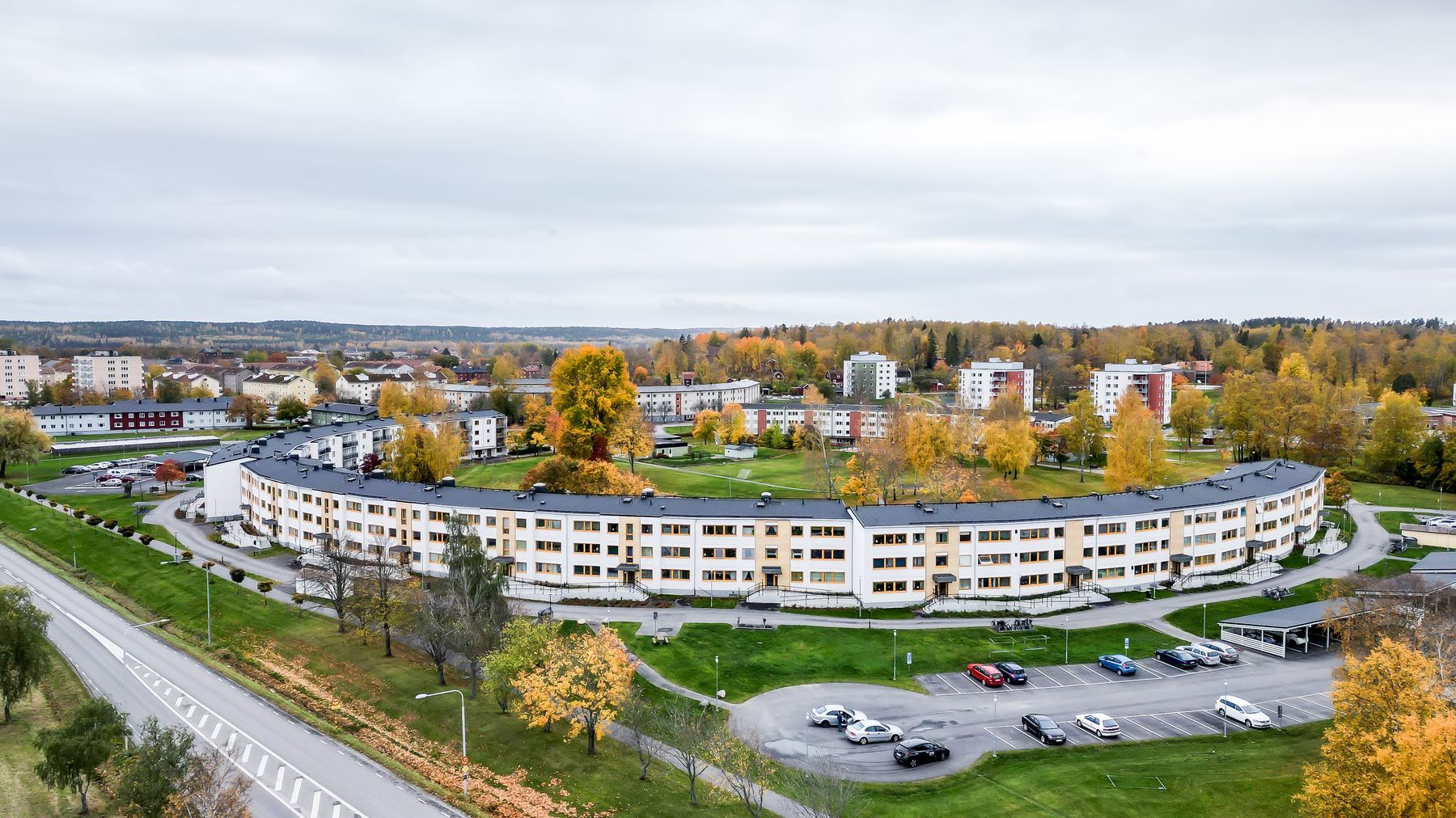 Flygbild över det lugna bostadsområdet i Hallsberg med grönytor och parkering